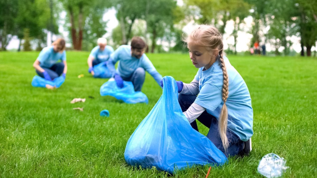 School girl picking up rubbish at Cheapest load of rubbish Sydney